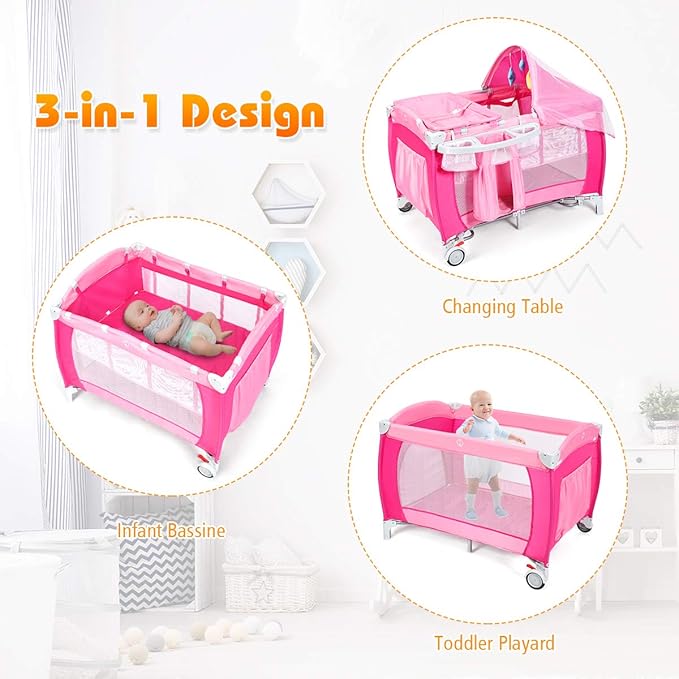 Costzon 4 in 1 Pink Pack and Play with Bassinet, Portable Baby Playard with Adjustable Canopy, Side Zipper Entrance, Music Box, Wheels/Brake, Foldable Infant Pink Bassinet for Baby Girl Toddlers