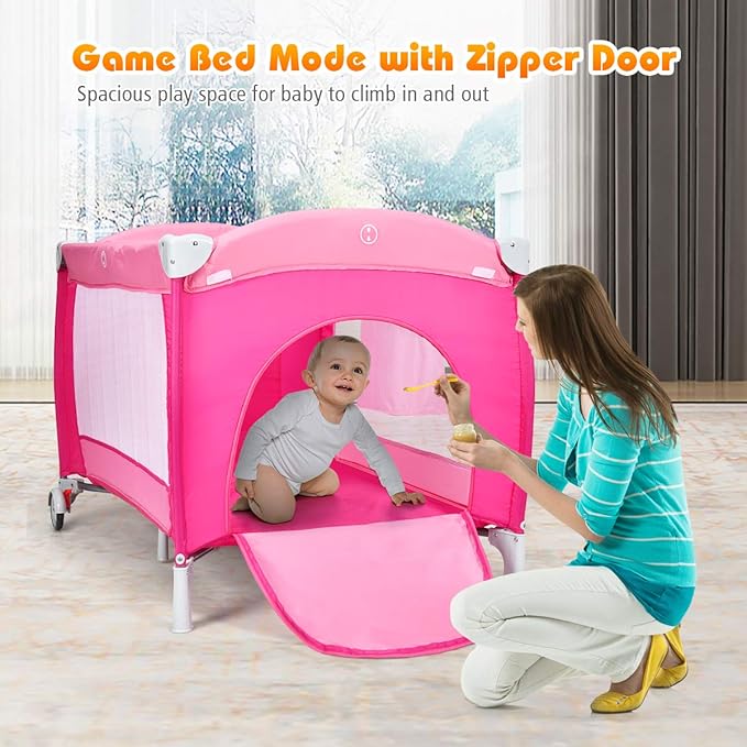 Costzon 4 in 1 Pink Pack and Play with Bassinet, Portable Baby Playard with Adjustable Canopy, Side Zipper Entrance, Music Box, Wheels/Brake, Foldable Infant Pink Bassinet for Baby Girl Toddlers