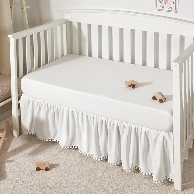 TILLYOU Baby Crib Skirt Girls Boys, Ruffled Bed Skirt with Pompoms, 28”x 52”, 14'' Drop, White